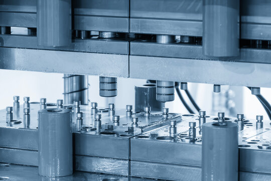 The metal forming process by progressive die in the light blue scene.