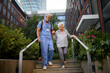 © Halfpoint - Caring healthcare worker helping elderly woman walk the stairs.