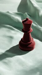 Poster - Velvet Queen Chess Piece on Soft Green Fabric Evoking Luxury and Strategy with Elegant Shadow Play for Conceptual Game Design and Refined Aesthetic Appeal