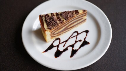 Poster - A slice of cake on a white plate, topped with chocolate frosting and drizzled with chocolate sauce.