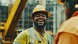 © Oksana Arhangelova - Smiling african male construction worker in yellow hard hat on site