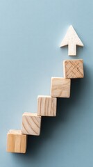 Aufkleber - Wooden blocks forming a staircase leading to a white arrow on a blue background symbolizing business growth and success concept with a minimalist style and a top view