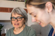 © michnik101 - Senior woman and healthcare worker reviewing blood pressure readings together at home, concept of elderly health monitoring