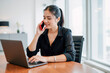 © Rick Captura - Woman Engaged in Phone Call While Working on Laptop at Table