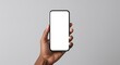 © Julija - Close-up of dark-skinned hand holding smartphone with blank screen mockup, isolated on gray background with copy space for mobile app or digital product ad
