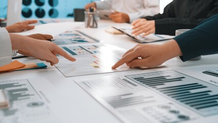 Poster - A collaborative business meeting scene showcasing diverse professionals engaging in analysis of charts and graphs, highlighting teamwork and communication in a modern office setting. SACTR