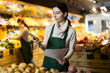 © JackF - Young woman seller with mobile phone conducting inventory with checklists in vegetable shop
