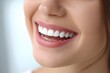 © ArtStock - Close-up of a young smiling mouth showing white teeth, clean studio background