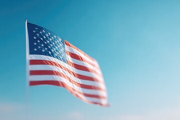 Poster - minimalistic image of single american flag gently waving against clear blue sky with ample copy space