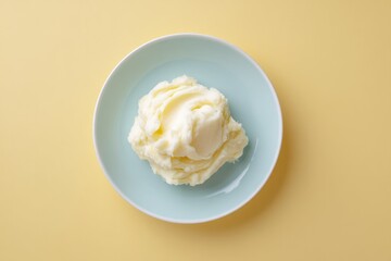 Poster - top-down view of single serving of mashed potatoes elegantly plated on clean solid color background