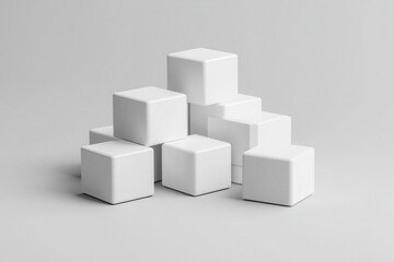 Poster - A minimalist arrangement of several white cubes stacked on top of each other on a gray surface