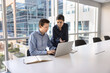 © fizkes - Two colleagues using laptop, preparing report or presentation, analyze received data, researching information, using project management tools to track progress, analyze budgets and revenue. Workflow