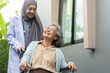 © Art_Photo - Muslim female doctor caregiver assisting elderly patient in wheelchair, healthcare service, senior care concept, medical support, rehabilitation, health professional with stethoscope providing help