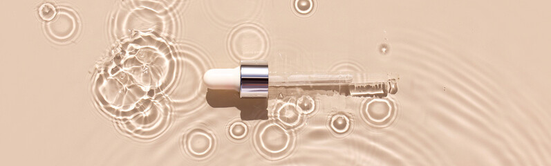 Fototapete - pipette serum in water on beige background ripples water drops natural sunlight