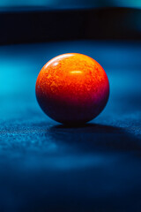 Aufkleber - Close-up of a single orange billiard ball on a dark blue pool table.