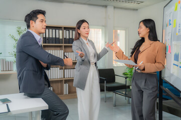 Poster - Asian businesspeople discussing marketing strategy during meeting in modern office, businesswoman presenting sales and profit data on whiteboard to her colleagues