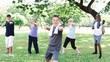 Group of diverse seniors exercise outdoors, healthy and energetic. Active diverse senior group enjoy fitness exercise in park. Healthy diverse seniors exercise in park, enjoy active outdoor fitness