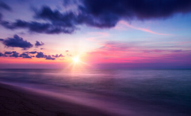 Wall Mural - calm colored sea and sky at sunrise