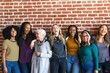 © Rawpixel.com - Diverse group of women smiling, standing against a brick wall. Women of various ethnicities, casual attire, joyful expressions, togetherness, unity. Diverse group of women united, standing together.