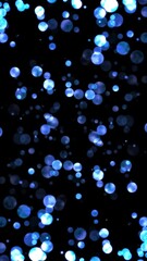 Wall Mural - blue flow from big shiny blue particles, vertical direction, loop transparent video, vertical social media motion background