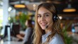 © SUPHAKPHEN - Smiling female customer service representative with headset in modern office environment, providing friendly and professional support.