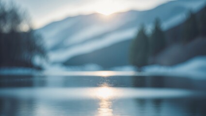 Aufkleber - Tranquil frozen lake with shimmering sunlight reflected on its blurred background, set amidst mountains and trees in a calm landscape
