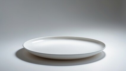 Poster - Single white ceramic plate placed on a white surface