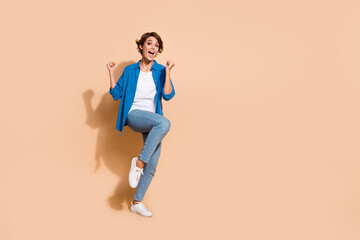 Aufkleber - Full body length photo of overjoyed girl in shirt raise fists up winning extra salary at corporate event isolated on beige color background