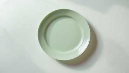 Poster - Round ceramic plate without contents isolated on background with clipping path. Viewed from above
