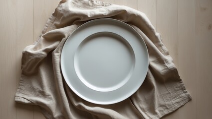 Poster - White circular plate placed on a wooden table with a linen napkin, seen from above