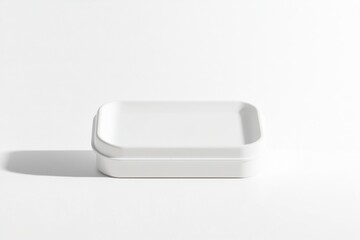 Fototapete - A minimalist white tray with rounded corners resting on a white surface, casting a subtle shadow, showcasing simplicity and modern design.
