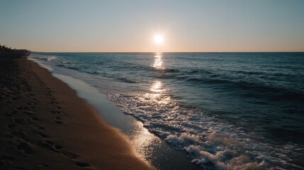 Aufkleber - Golden rays stretch across the calm ocean as the sun sets over a peaceful beach, creating a tranquil atmosphere with soft reflections on the water