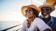 © dvoevnore - Happy middle-aged black couple enjoying yacht vacation under sunny sky