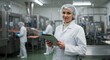 © rdkcho - Confident Female Food Processing Supervisor Using a Tablet in a Modern Factory Environment