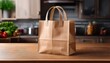 © Preston - beige paper grocery bag standing on wooden kitchen table