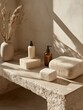 © Natchanok - Organic spa display of hygiene containers with stone cubes and decorative dried floral arrangement under sunbeam