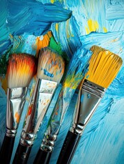 Poster - Creative art background with colorful paint texture and assorted paintbrushes for artistic designs