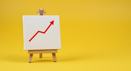Aufkleber - Upward Red Arrow on White Canvas Displayed on Wooden Easel Against Bright Yellow Background Symbolizing Business Success