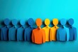 © Worrapol - Paper cutout figures in blue and orange colors on a turquoise background representing diversity and teamwork in a creative and abstract way
