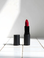 Poster - Deep red lipstick is stylishly displayed against a clean white background on a sleek tile countertop._00001_