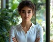 © Wardani - Confident woman, arms crossed, white shirt