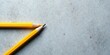 © vattana - Two Yellow Pencils Poised on a Gray Surface, Ready for Artistic Creation or Note-Taking