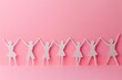 © Imagentive - Pink Paper People Holding Hands Unity Celebration