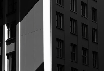 Wall Mural - stark contrast of light and shadow on a monochrome building facade, surface, horizontal