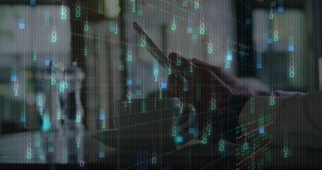 Poster - Right hand holding smartphone in modern tech workspace, showing binary code and digital charts