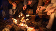 © kinomaster - Friends sitting around a campfire in the woods on a winter evening