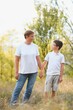 © Serhii - Grandmother walking with her grandson. Relaxing and joying in sunset