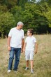 © Serhii - Happy weekend concept. happy grandfather and grandson are walking in the park