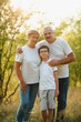 © Serhii - Grandfather grandmother and grandson having fun outdoors in park