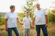 © Serhii - Grandparents and grandson together in autumn park